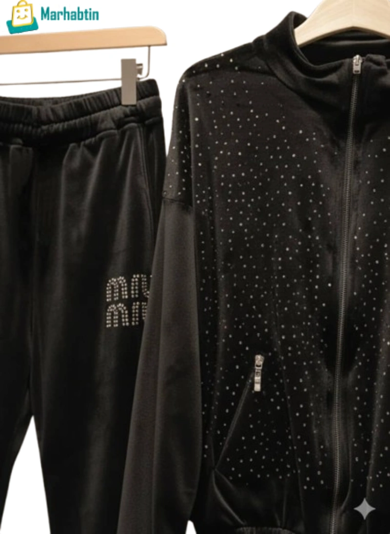 black-velvet-detail-crystal-miumiu.webp Close-up of Velvet Fabric with Diamond/Crystal Studs and Miu Miu Logo.